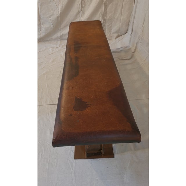 This is a truly one-of-a kind vintage leather bench with a custom truss style base and beautifully worn leather cushion....