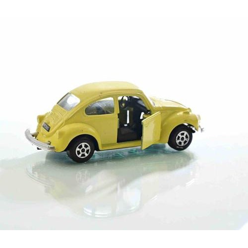 A charming polistil die-cast metal model of the iconic volkswagen maggiolino (beetle), finished in bright yellow and...