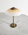 A rare and decorative Danish mid century desk table lamp in patinated brass with a beautiful frosted yellow white opaline...