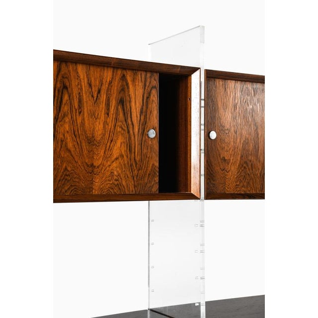 This very rare freestanding bookcase, designed by poul nørreklit and produced by sigurd hansen møbelfabrik in denmark...