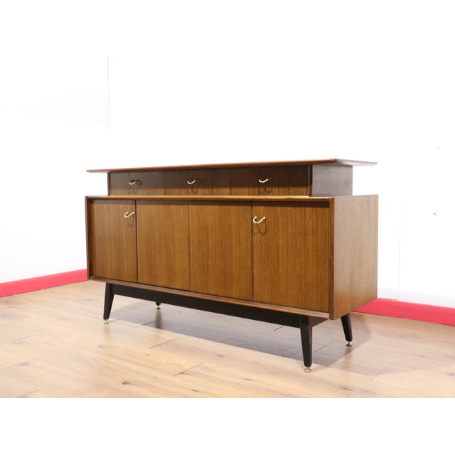 A gorgeous tcredenza made by renowned British furniture maker G Plan, this Mid Century Modern Vintage Afromosia Credenza...