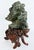 Asian Carved Figurative Precious Stone Sculpture on Root Stand Offered for sale is a hand-carved green mineral sculpture...