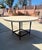 Wonderful outdoor MTD table, it has a Black/bronze lightly textured powder coat finish. The top of table is Crema Marfil.