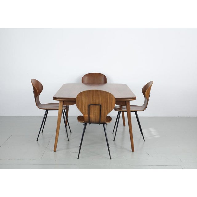 The table features an extendable table top with walnut veneer for extension. Either one or both sides can be pulled out....