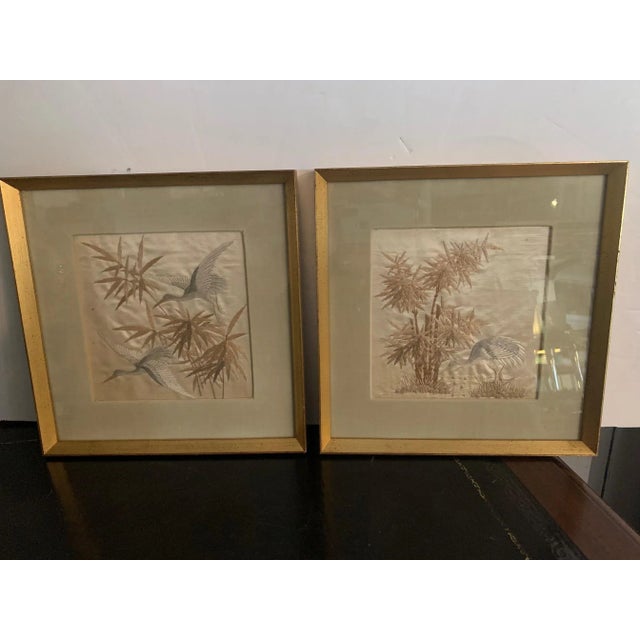 Lovely pair of fine silk needlework of herons and bamboo having subtle color palette of platinum grey, silver, white and...