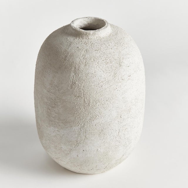 In a textured cold finish, this rotund shaped vase adds a touch of antiquity. Add a few faux stems or branches for color...