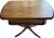 A well-proportioned vintage two-tier pedestal table with a warm reddish wood tone. The floating shelf and slender turned...