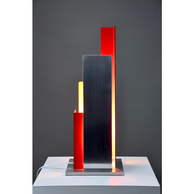 Step into the golden era of italian design with this stunning sculptural aluminium table lamp, in the style of the elusive...