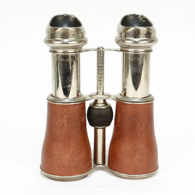 A stylish pair of antique binoculars. By Marquise of Paris. With relatively low-power magnification, chromed brass, curved...