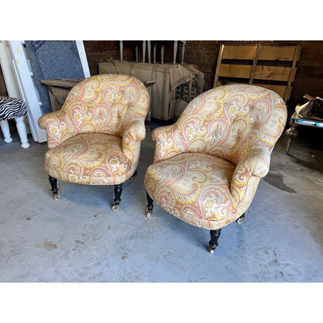 A stunning, authentic pair of antique French fauteuils crapaud (historically known as "crapaud" or "toad" chairs)....