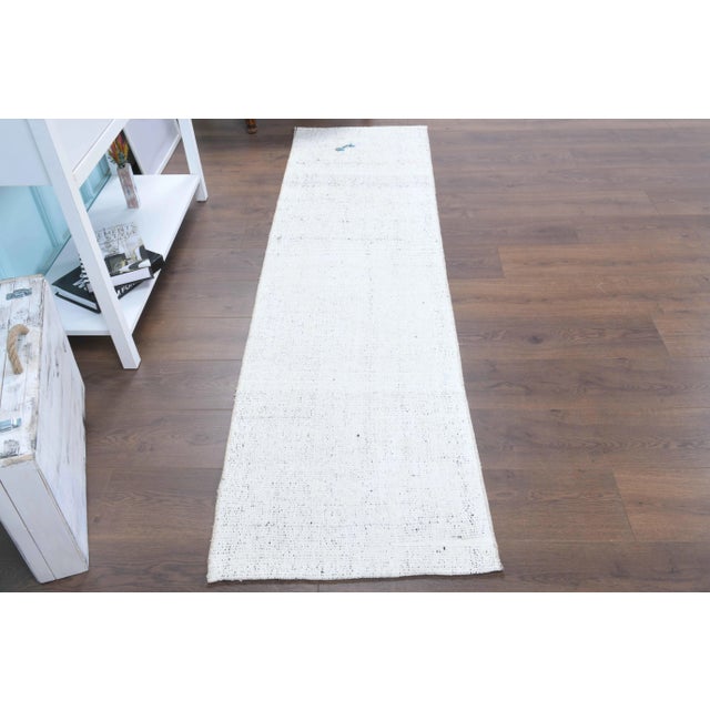 Vintage Turkish Hand-Knotted vintage rug is a semi-Vintage kilim runner rug.'70s Eastern region of Turkey's unique rug is...