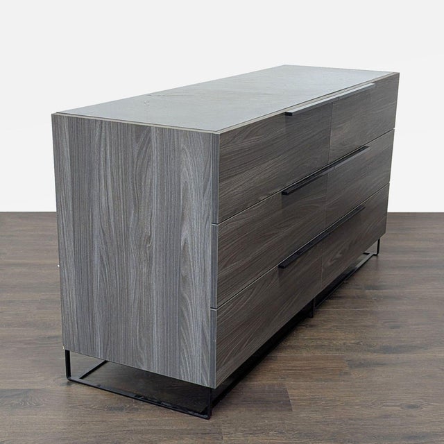 This Modrest dresser features a sleek gray wood finish and black metal legs. It offers six spacious drawers for easy and...