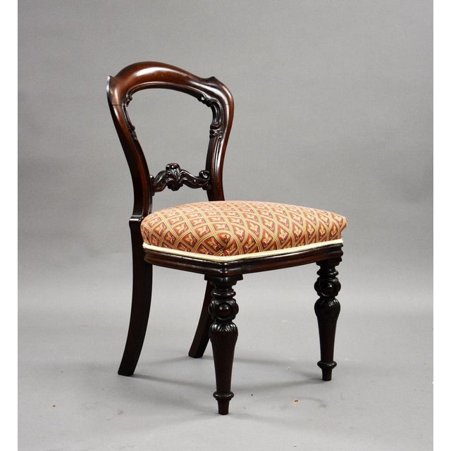 A charming set of four Victorian mahogany dining chairs, dating to the mid–late 19th century, offering elegant shaping and...