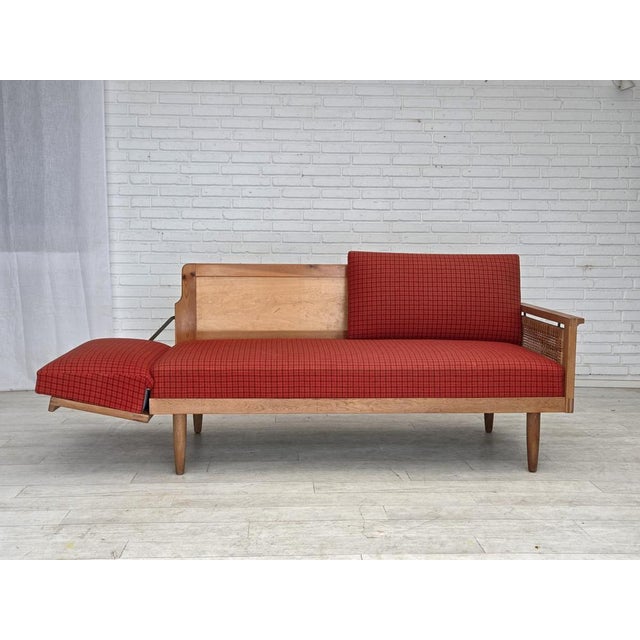1970s, Danish drop arm daybed/sofa by Illum Wikkelsø. Original orange/red furniture wool, furniture mesh, springs in the...