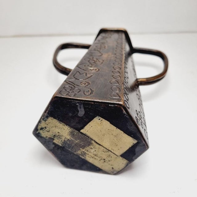 Art Deco style brass vase with handles from the early 20th century. Hand-engraved, its surface is covered with openwork...