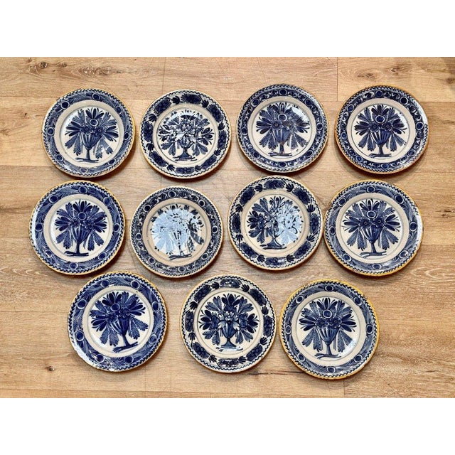 Rare set of 12 Delft tin-glazed blue and white soup plates, 18th Century. Each centered by a large floral design or...