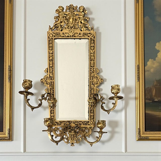 This offering is for a single antique Baroque Revival wall mirror, crafted in solid cast brass and dating to the late 19th...