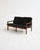 Rosewood two-seater sofa with black leather tufted cushions. Designed by Illum Wikkelsø for CFC Silkeborg, 1960s....
