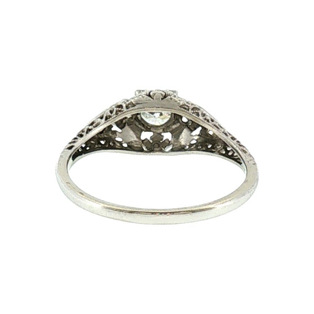 A 1930's platinum engagement ring featuring an Old European cut diamond. The primary stone is 0.34 carats with VS2 clarity...