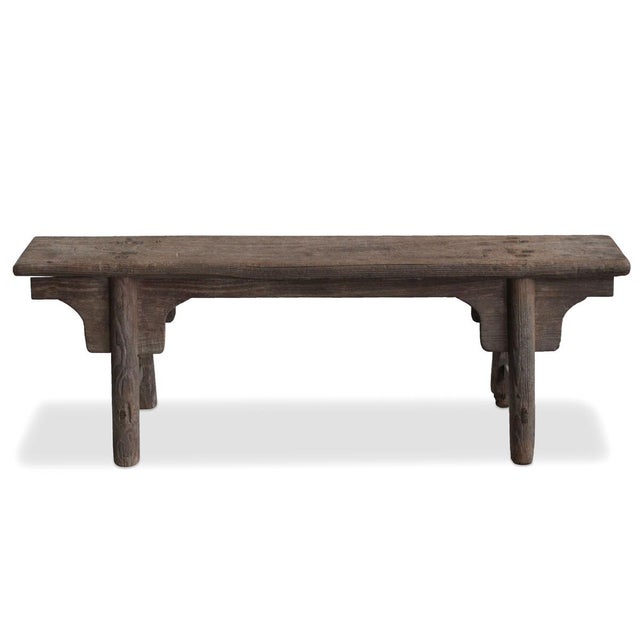 This simple, narrow bench is in elm wood and styled in a classic Chinese design with rounded legs in a splayed A-frame...