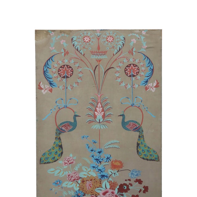 A tall panel painted with images of peacocks perched on rings and a bouquet of multicolored flowers in a vase. Two...
