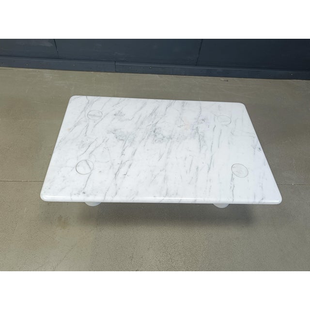 Timeless carrara marble coffee table with interlocking legs designed by Angelo Mangiarotti for Up&Up. Gorgeous natural...