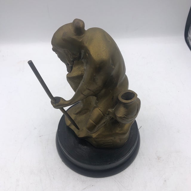 Heavy brass Asian man with rod and jug on black resin base. Great detail that would look great in a Hollywood Regency or...