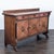 This classic sideboard has a rich wood finish and carved details. It features three spacious drawers and three cabinet...