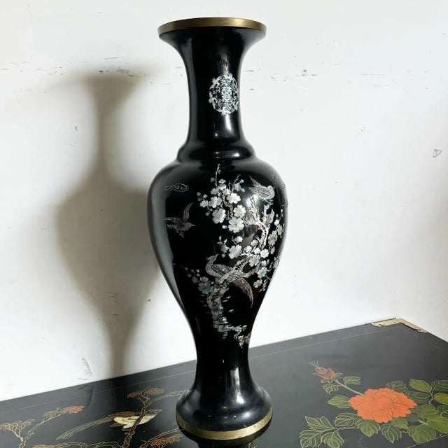 This exquisite Chinese vase is crafted from black lacquered brass and adorned with intricate mother of pearl inlays. The...