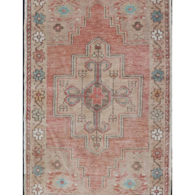 Measures:2'6 x 5. Layered floral medallion design in muted coral and taupe Oushak vintage rug from Turkey, Keivan Woven...