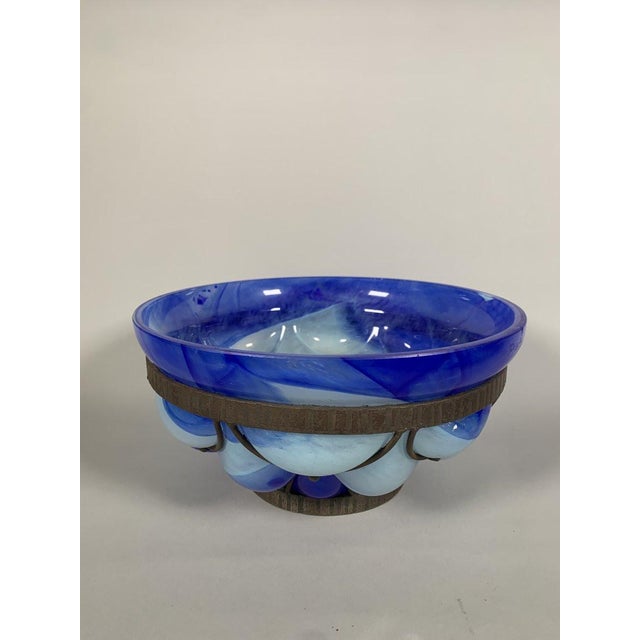 Blown glass bowl in a wrought iron frame. Signed André DELATTE (c.1887-1953), Nancy. Shaded blue and white glass. French...