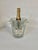 It's a champagne bucket, made of crystal, with geometric patterns on the points and diamonds that serve as handles. It's...