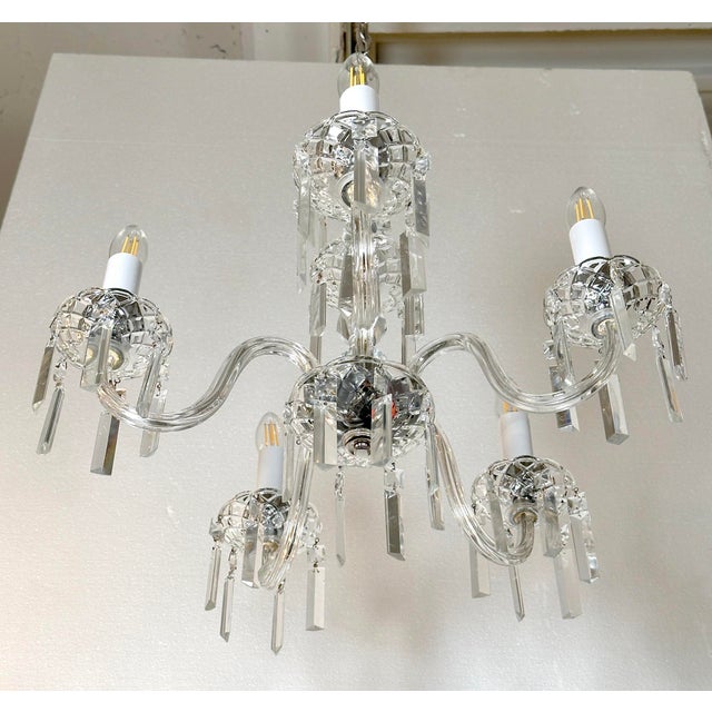This mid 20th century chandelier is constructed with a polished nickel finished frame and features five radiating glass...