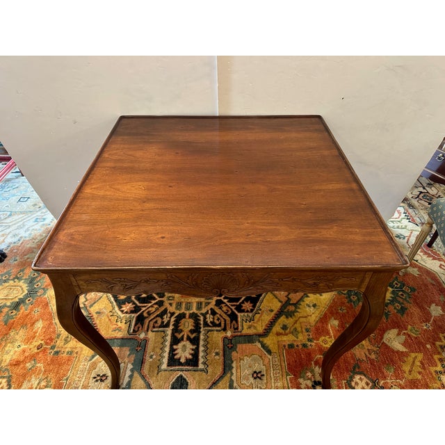 Lovely square Italian carved fruitwood game table with scalloped shells, elegant cabriole legs and single drawer.