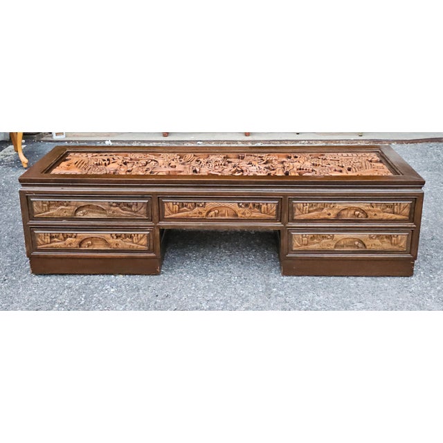 A intricately Hand-Carved Five-Drawer South East Asian Coffee Table with Glass Top Inset. Features 5 drawers flawlessly...