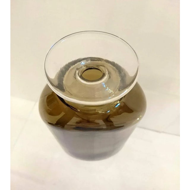 Hand blown vase designed by Eva Englund for Pukeberg Glass Manufacturer, Sweden in dark smokey colored glass that...