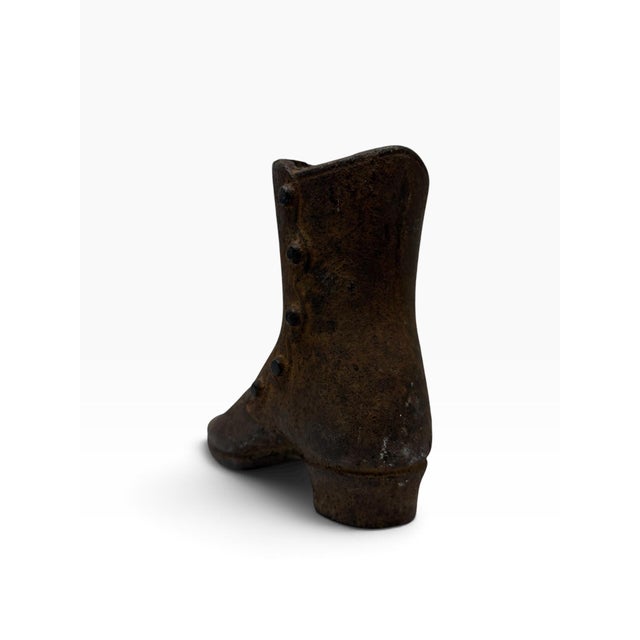 Breathe authentic primitive charm into your space with this rare, late 19th-century antique cast iron ladies' high-button...