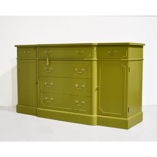 Vintage Georgian-style breakfront sideboard by Metz Furniture, newly painted in green, has a projecting center section and...