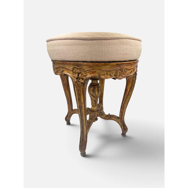An elegant French late 19th-century Louis XV Revival piano stool crafted in carved giltwood. The rotating cushioned seat...
