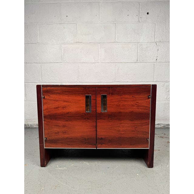 Refined mid-century nightstand crafted in rosewood and manufactured by Glenn of California. Features clean lines, rich...