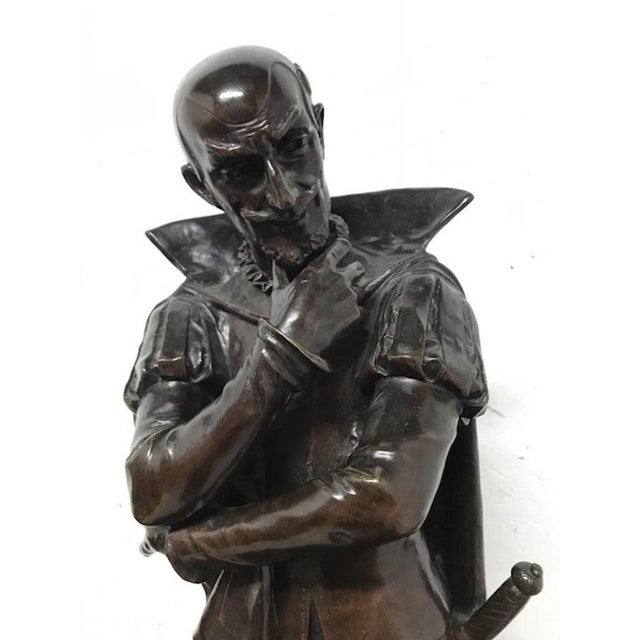 An 18th century bronze statue of a Shakespearean character in period dress with pensive look. Signed Pierre Marie Francis...