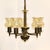Distinctive twisted central column with 5 curved brass arms each supporting a delicate swirled glass shade. Brass...