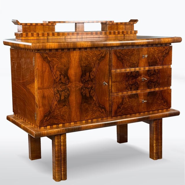 Period: Art-Deco, date of manufacture: 1930 - 1939, material: solid wood and walnut veneer. This chest of drawers is...