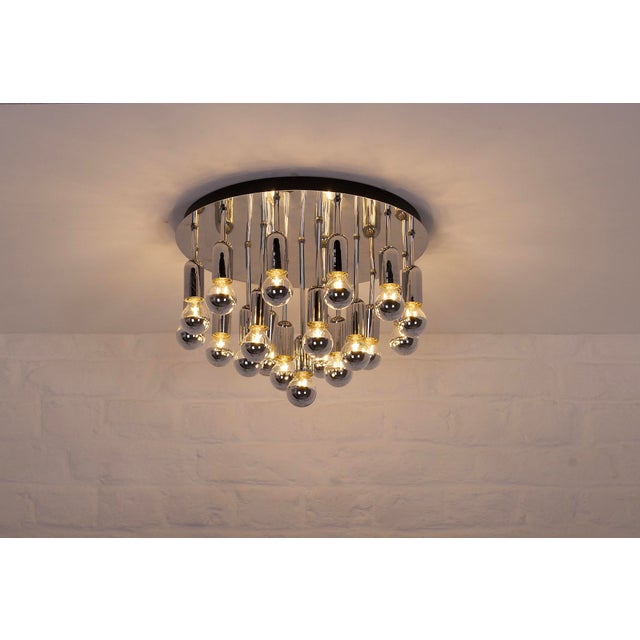 Chrome-plated steel ceiling light with 19 lights arranged in a circular cluster. 1970s edition, in the style of Gaetano...