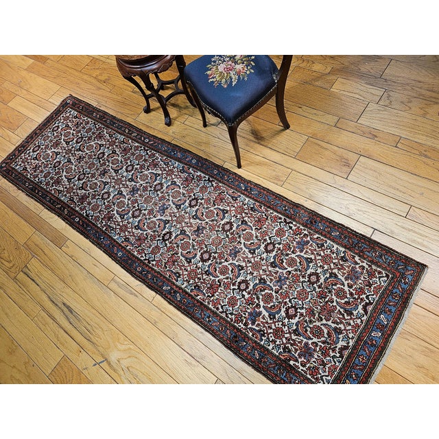 2’ 9” x 9’ 3” Vintage Persian Malayer runner in an allover Herati pattern in ivory, French blue, brown, and red colors...