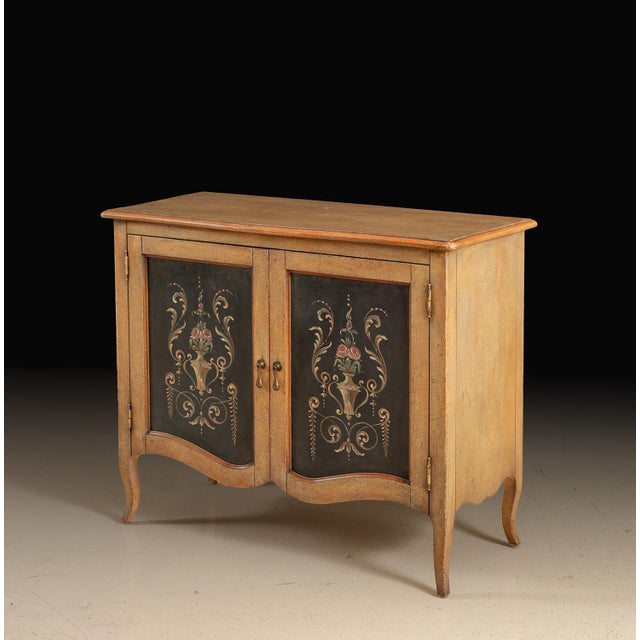 Handcrafted in Italy, this two-door sideboard features a hand-painted floral design set against contrasting black panels,...