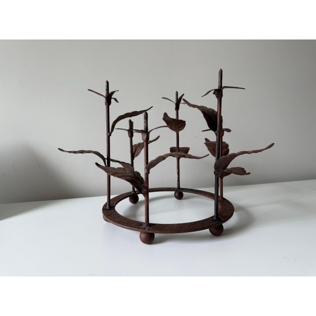 Vintage iron sculptural leaf stalk round primitive candelabra. The piece can accommodate six candles, with varied heights....