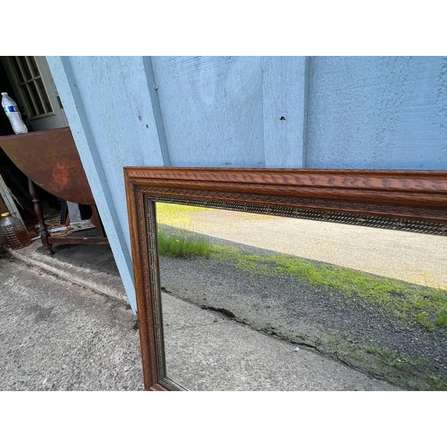 Antique Solid Oak Engraving Wall Mirror.Circa 1920. Approximate measurements: Height 28” width 34” depth 1.1/2”.