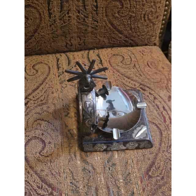 Unusual spur element ashtray with iron base and inland silver.