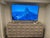 Modern sideboard is constructed from wood with a light natural finish. It has four doors featuring a geometric, diamond-...